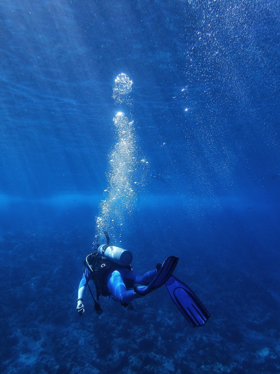 Scuba diver with bubbles trailing above